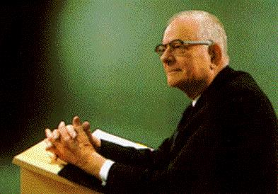 W. Edwards Deming speaking in front of a green board